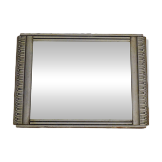 Art Deco mirror in silvered wood, stylised geometric frieze.