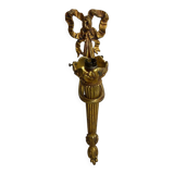 Bronze wall light, decorated with a bow and ribbon.
