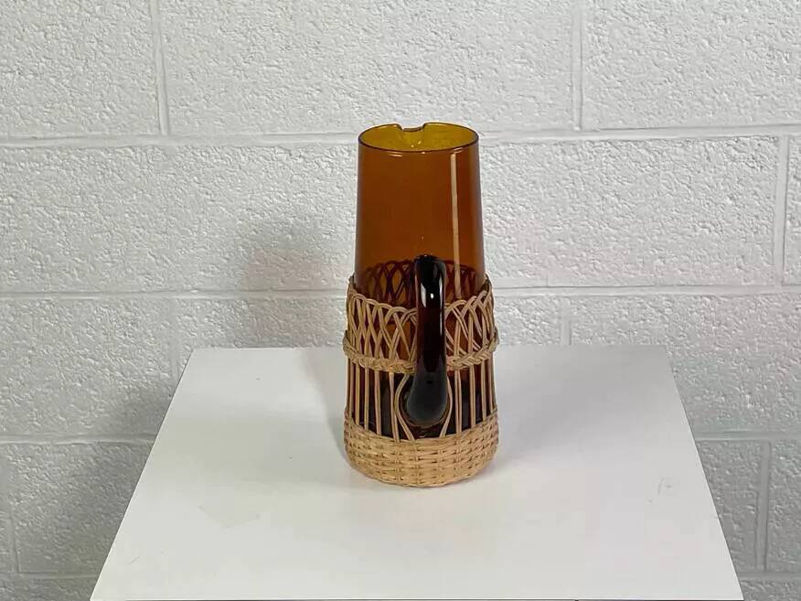 Vintage service for orangeade in amber glass and wicker.