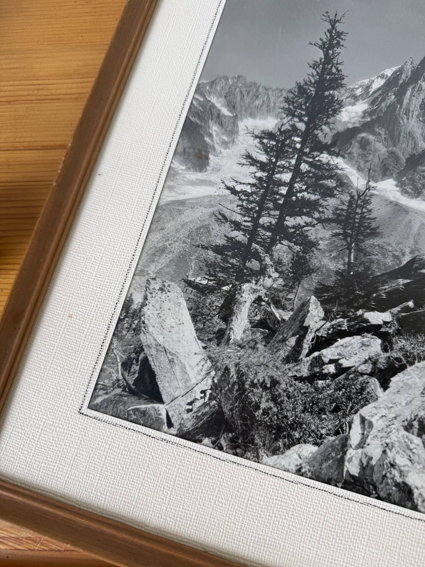 Framed old photo of a mountain landscape.