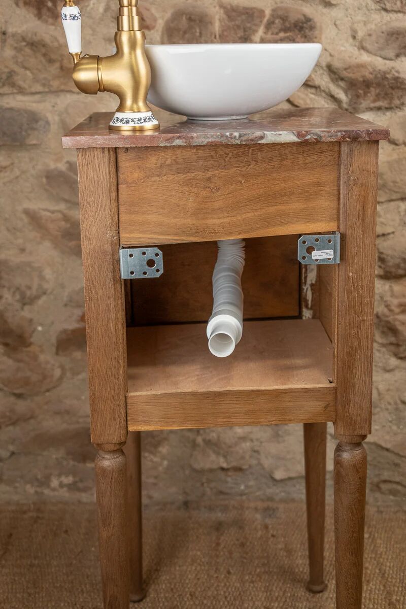 Small antique washbasin in wood and red marble.