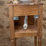 Small antique washbasin in wood and red marble.
