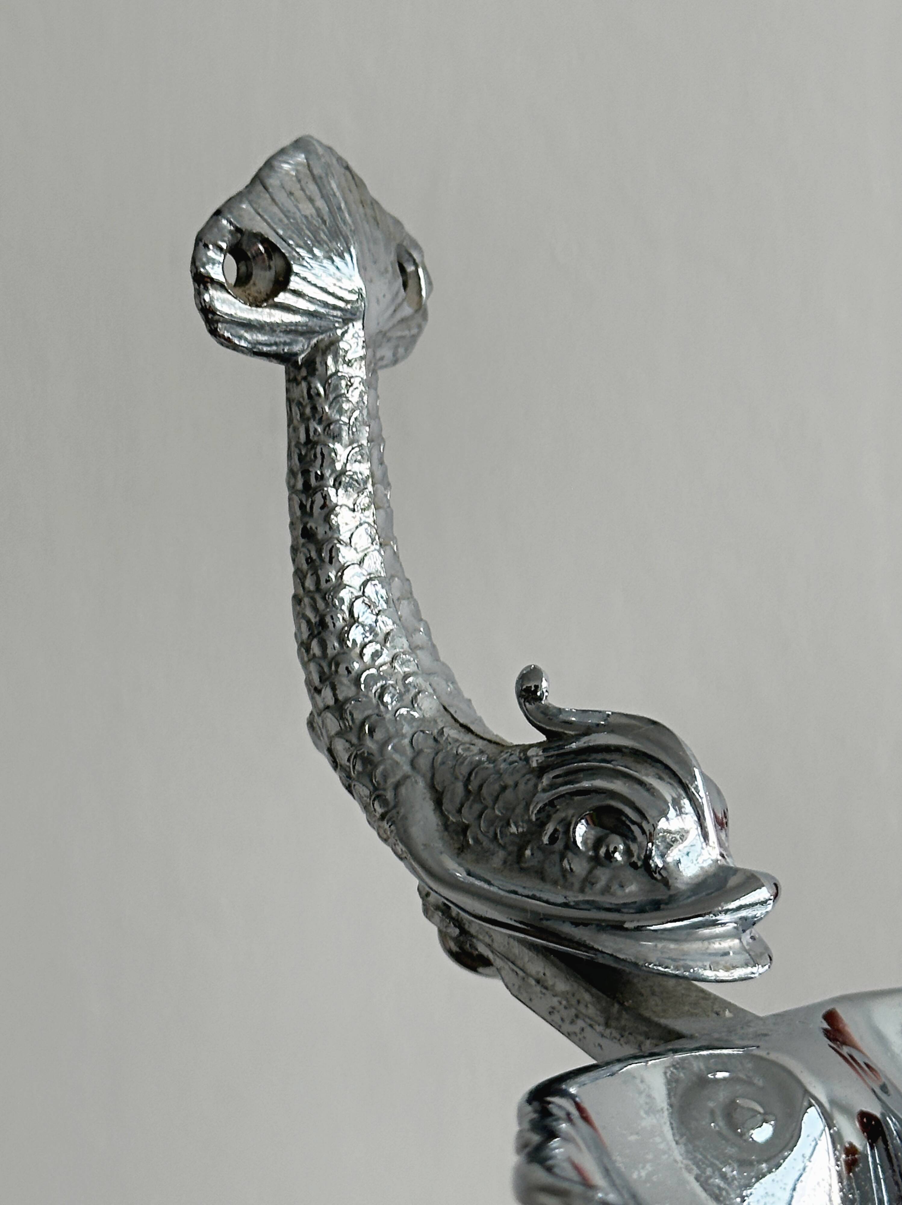 Soap dish, shell-shaped lightweight metal catchall.