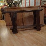 Small, very old, brutalist workbench equipped with a period workshop lamp
