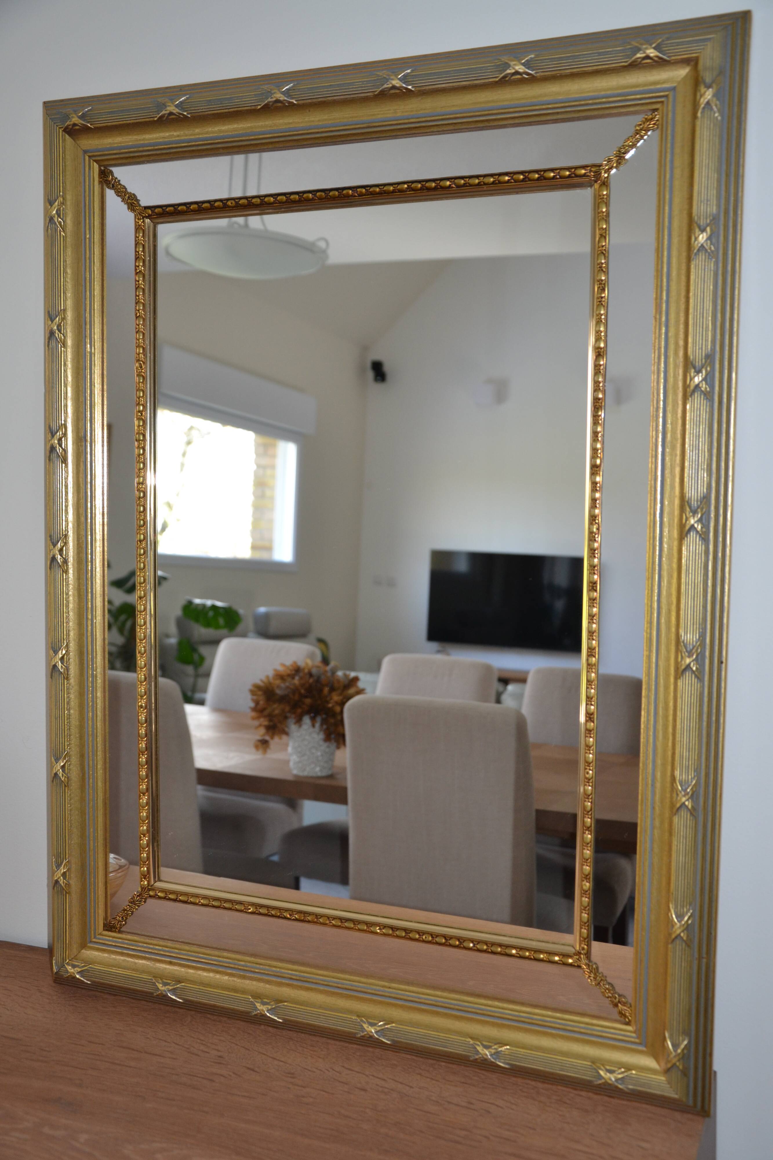 Large mirror with wooden gilded and carved frame.