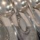 12 silver-plated dessert spoons with rocaille ribbon decoration, 18.5 cm