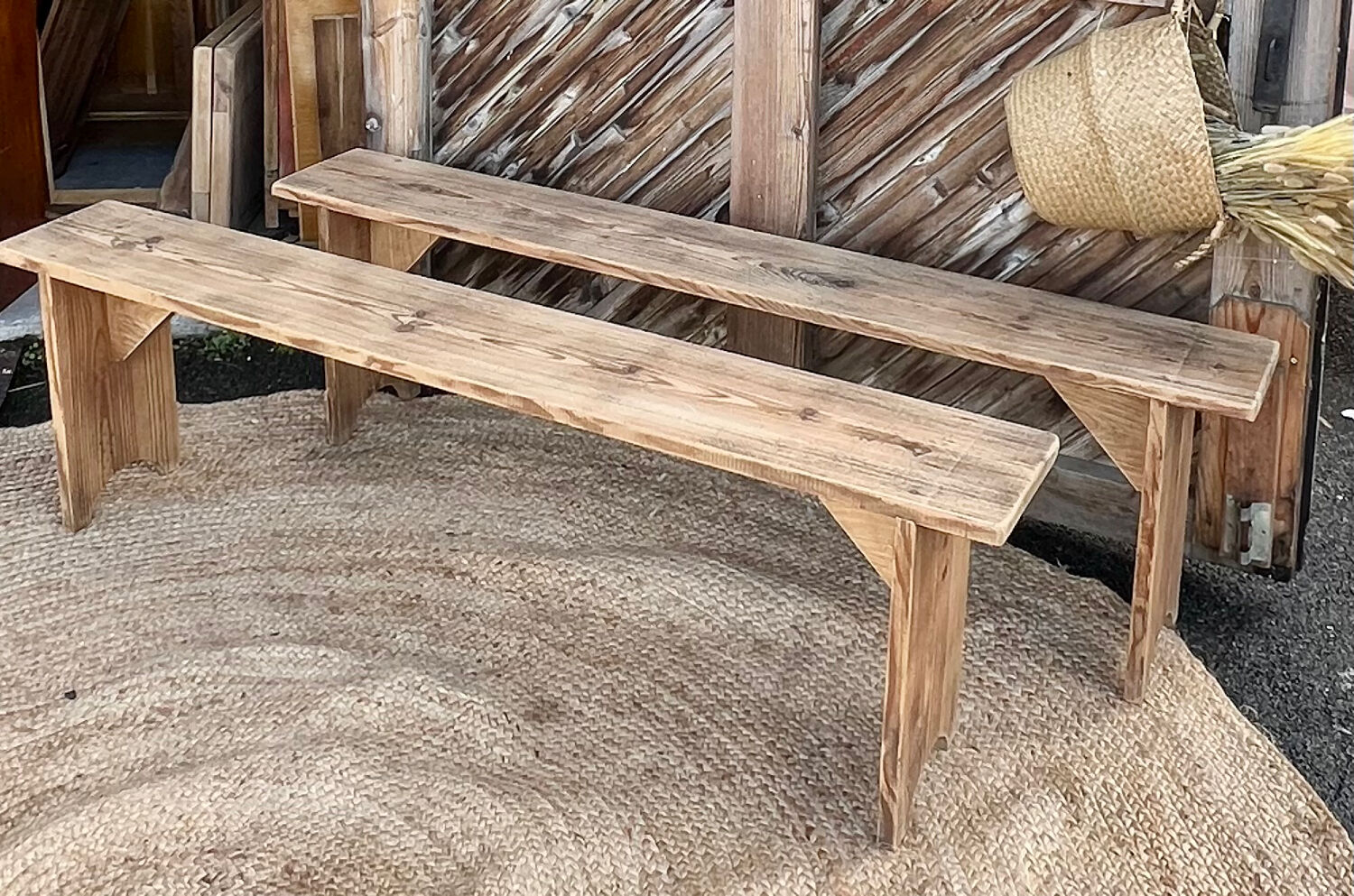 Pair of old farmhouse benches made of raw solid wood.