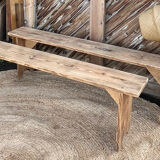 Pair of old farmhouse benches made of raw solid wood.