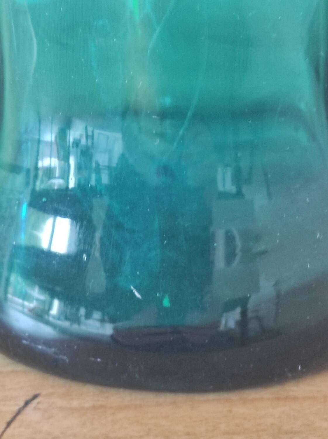 Blown glass vase with a flared neck and wavy rim.