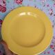 Old round plate in yellow faïence