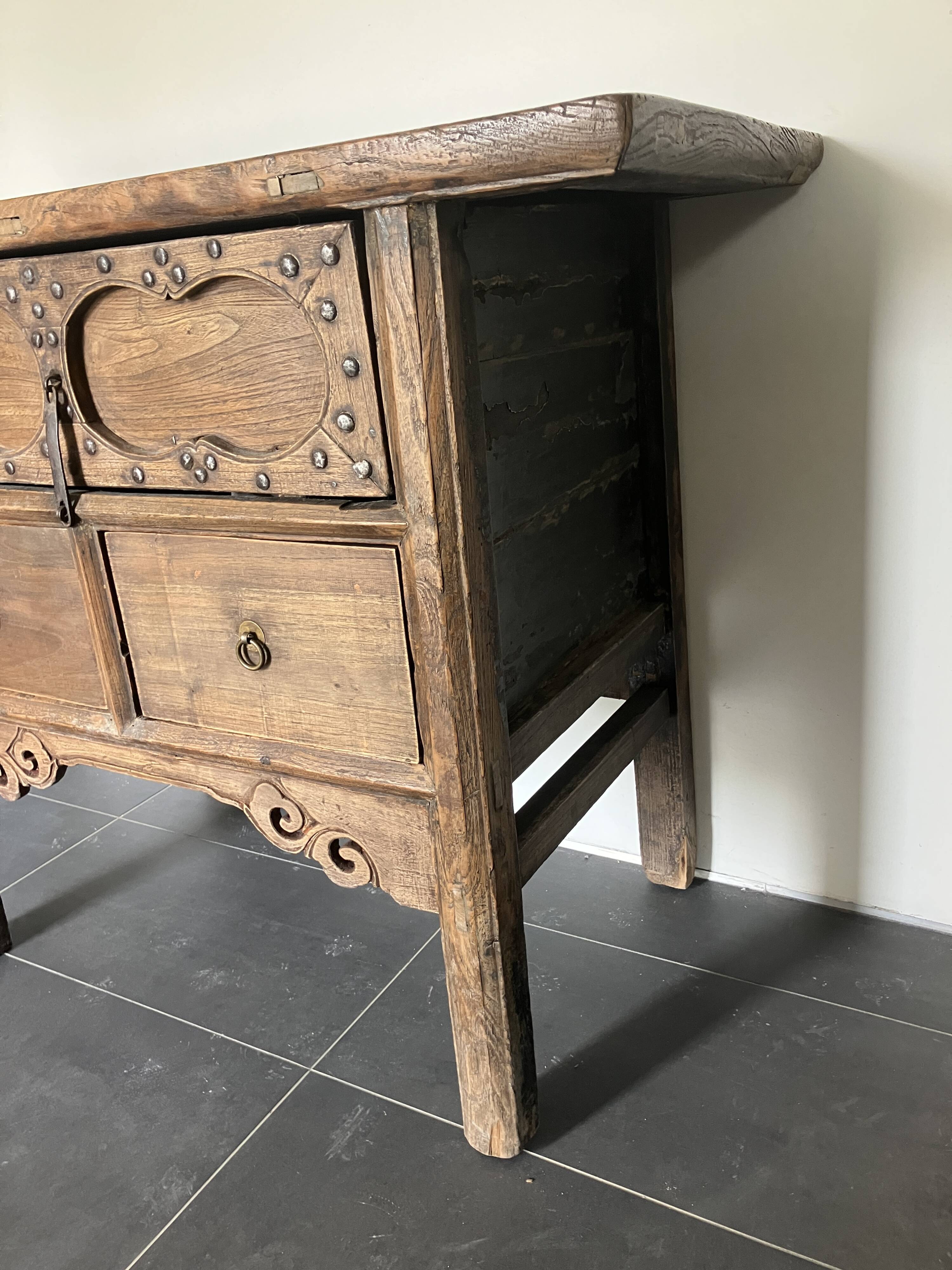 Very old elm wood with carved patterns and ironwork pieces.