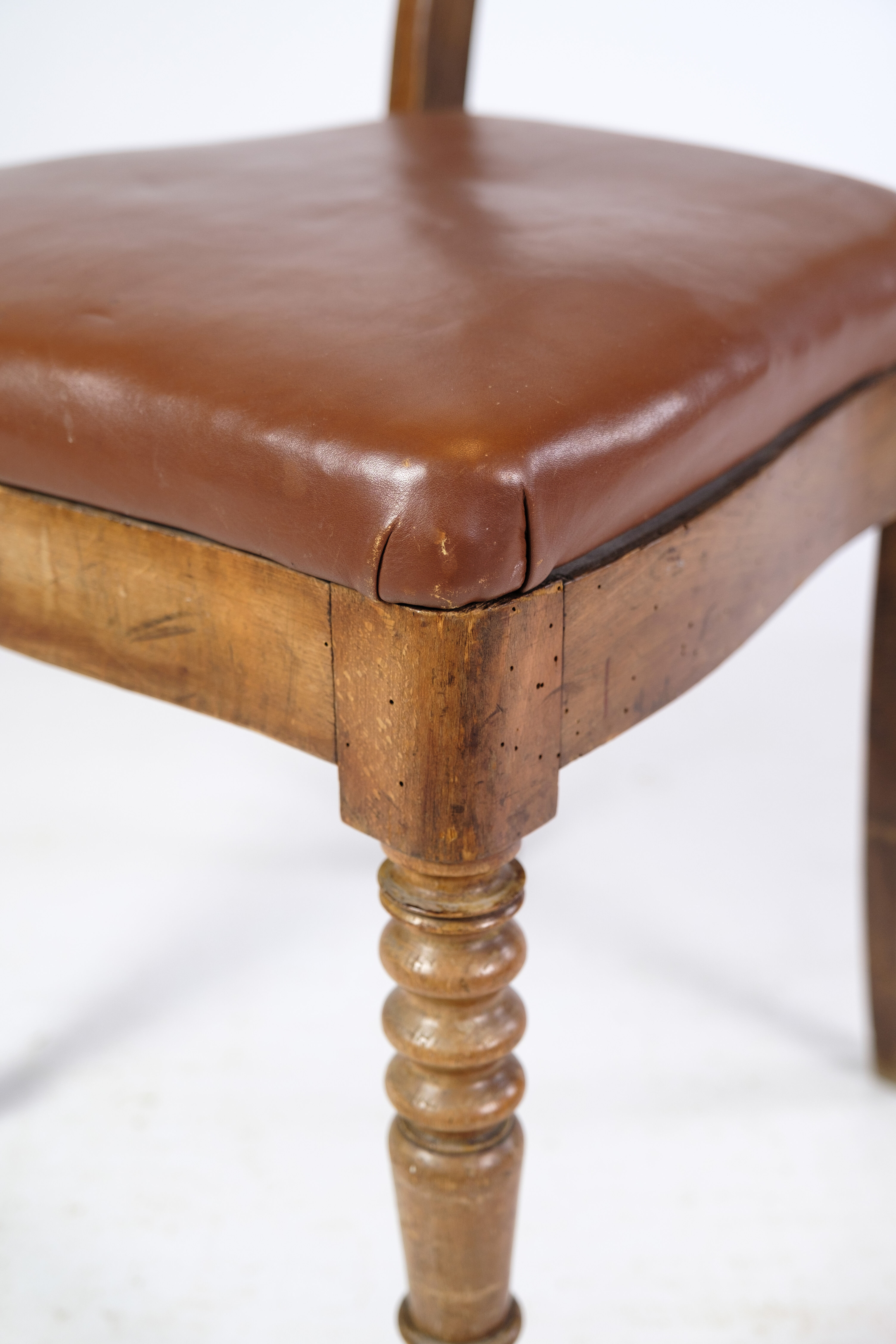 Set of eight late empire chairs in high quality brown leather in mahogany