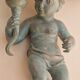 Pairs of wall lights, either two distinct cherubs.
