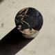 Small side table in black petrified wood with stripes and beige sides H28 D18.
