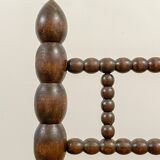 Low chair in beaded wood and straw