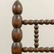 Low chair in beaded wood and straw