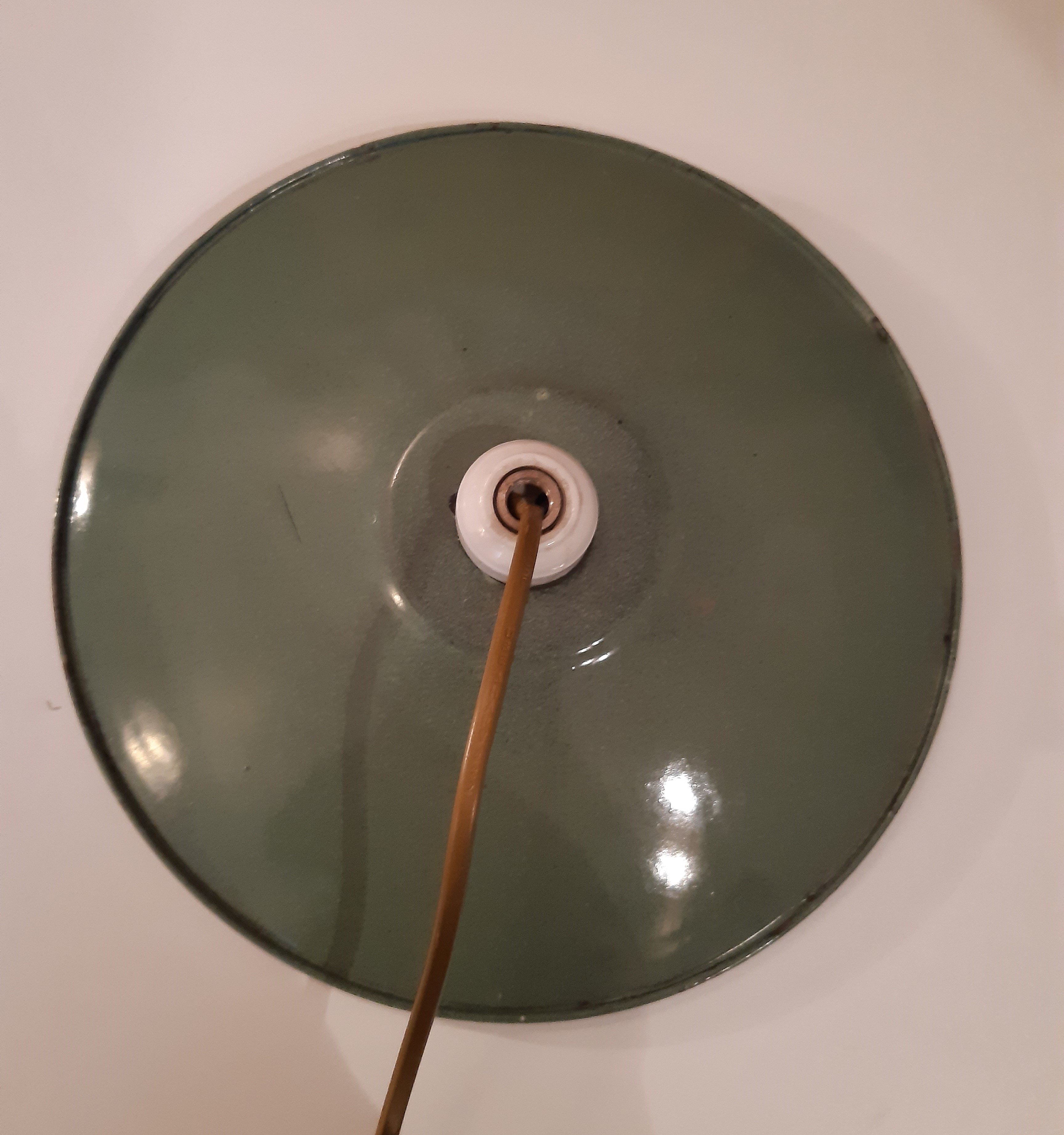 Old suspension in green enamelled sheet metal and porcelain socket to hang