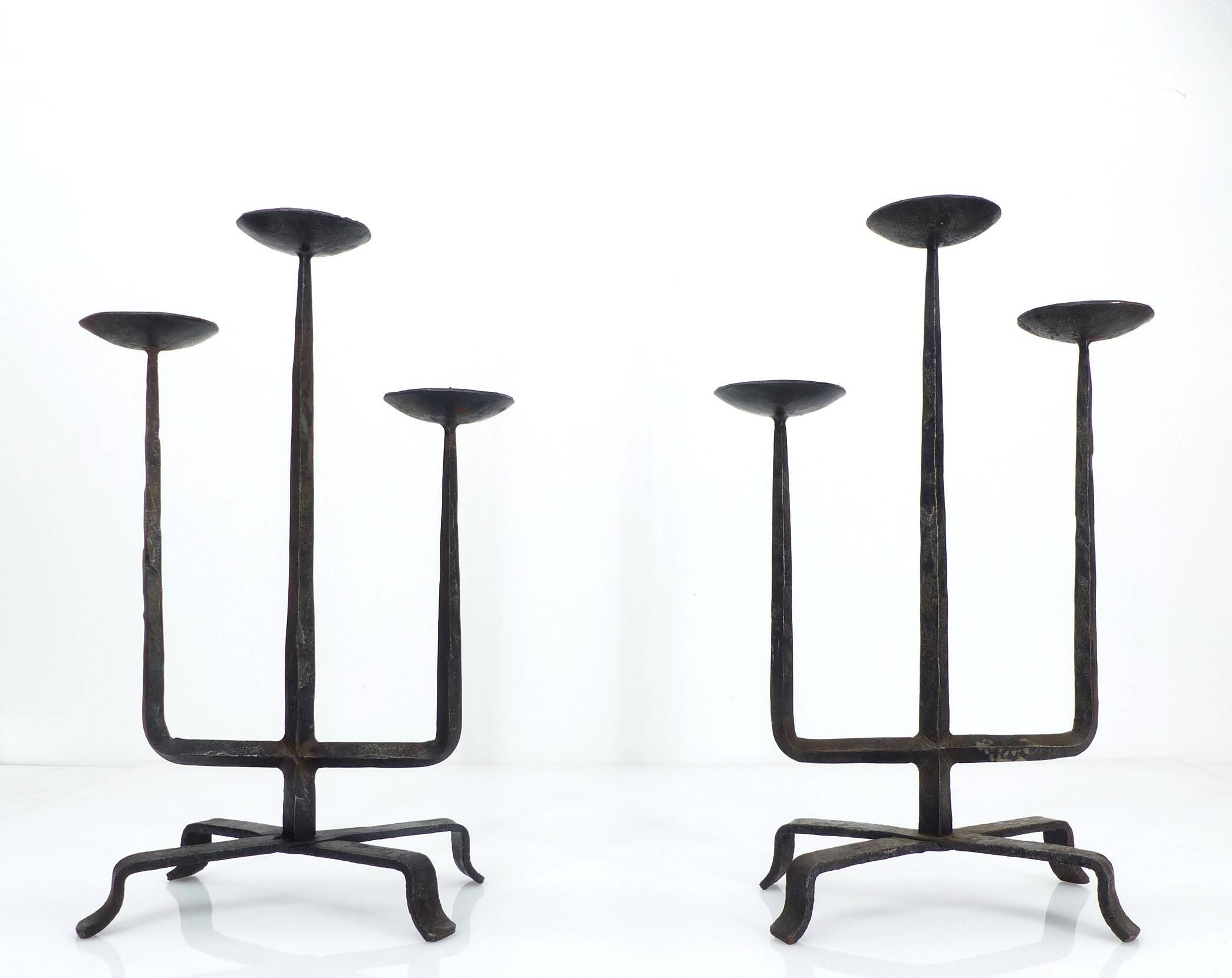 Pair of brutalist wrought iron candlesticks, France, three lights, signed