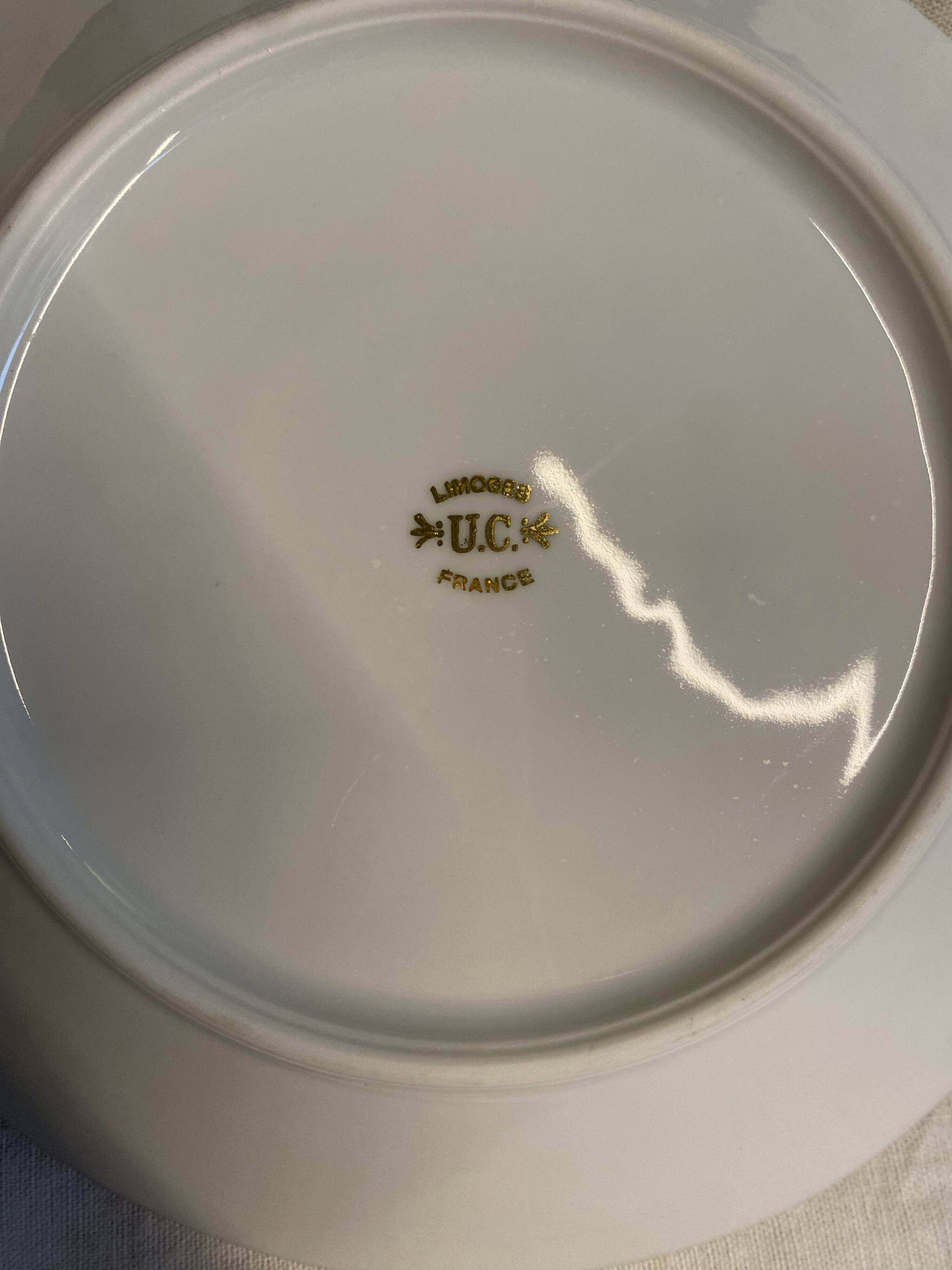 Vintage table service Limoges porcelain white with gold trim.