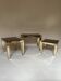Set of three nesting side tables in brass and smoked mirror.