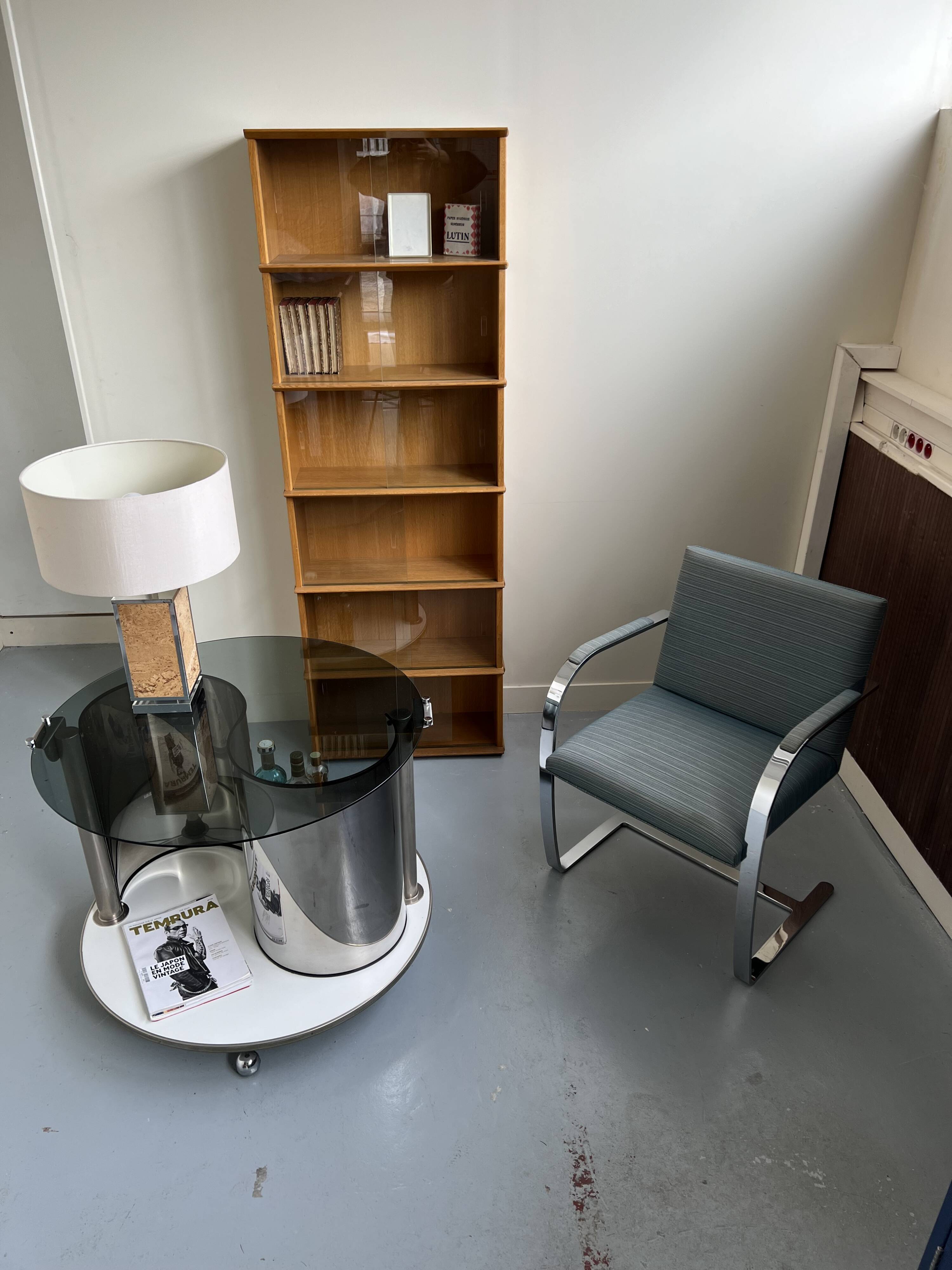 Vintage metal and smoked glass coffee table on casters bar