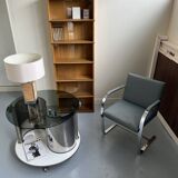 Vintage metal and smoked glass coffee table on casters bar