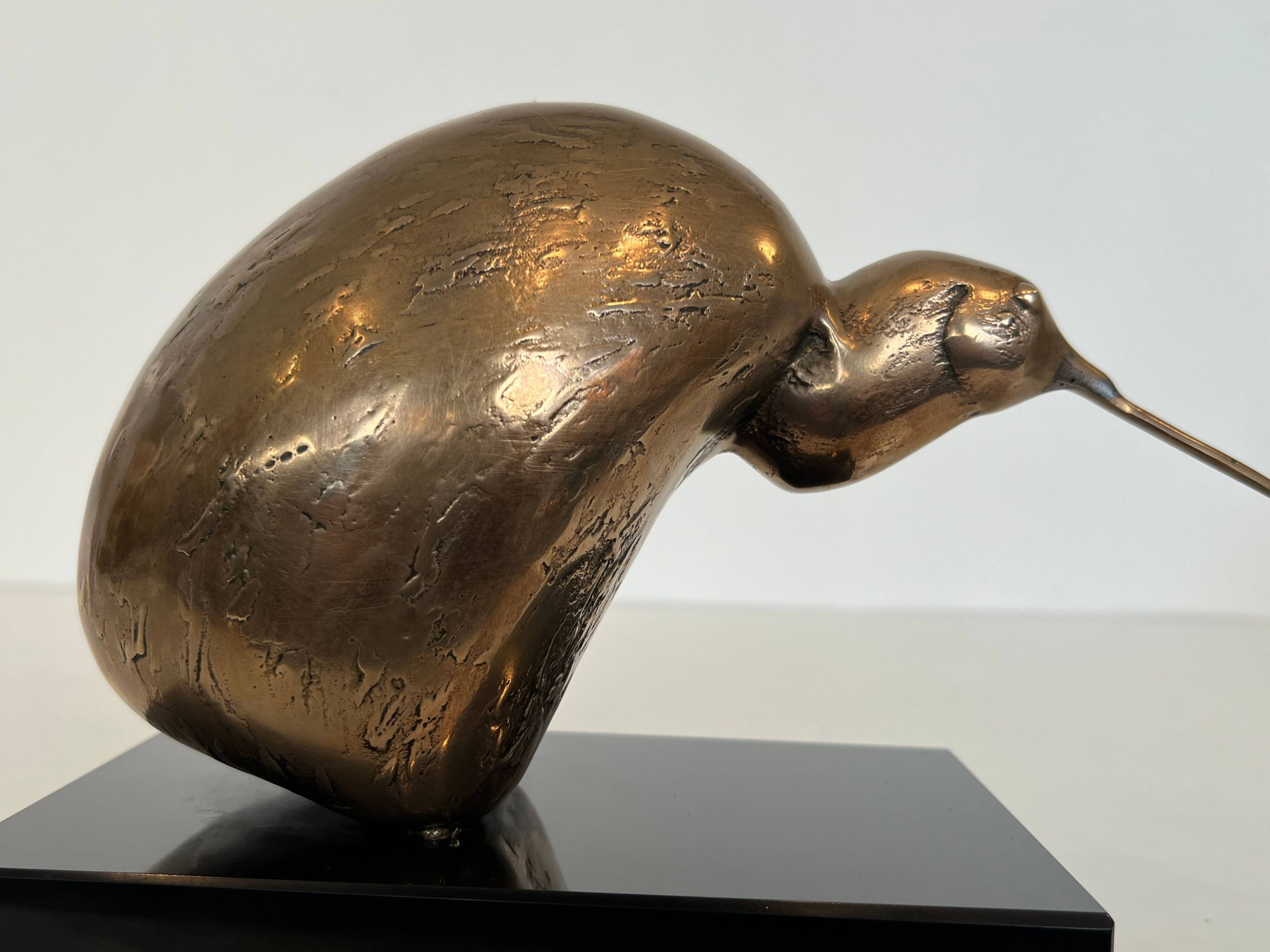 Bronze sculpture representing a stylised bird on a black marble base, signed and numbered.