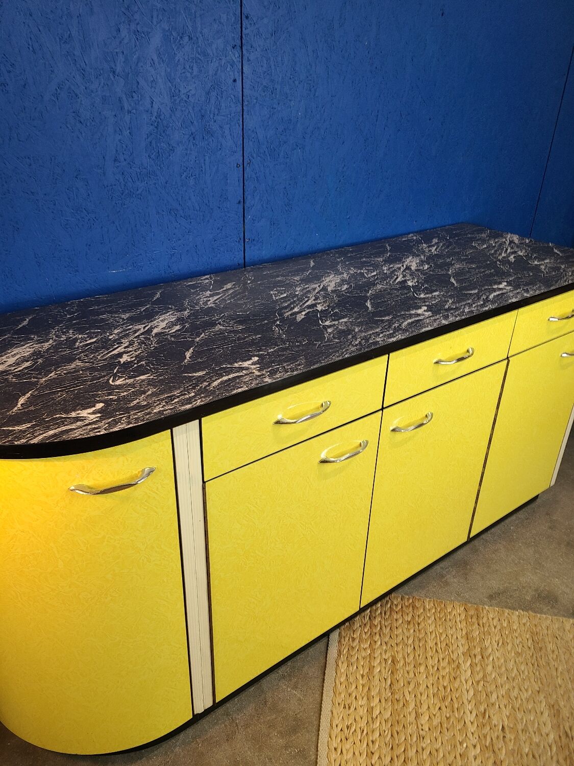 Vintage yellow sideboard, and black marble top.