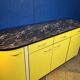 Vintage yellow sideboard, and black marble top.