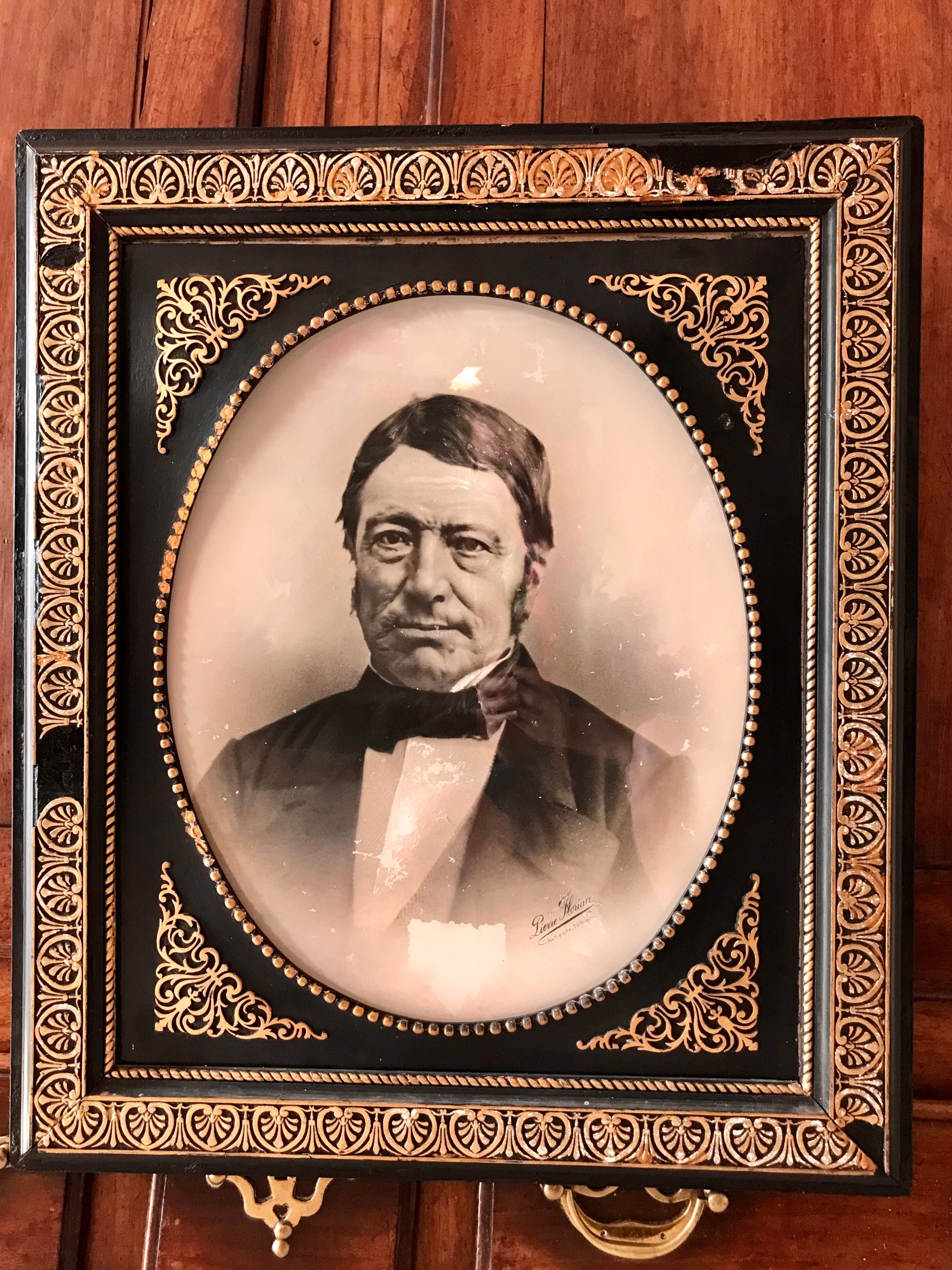 Black and gilded ebonite frame, wood and plaster 19th century