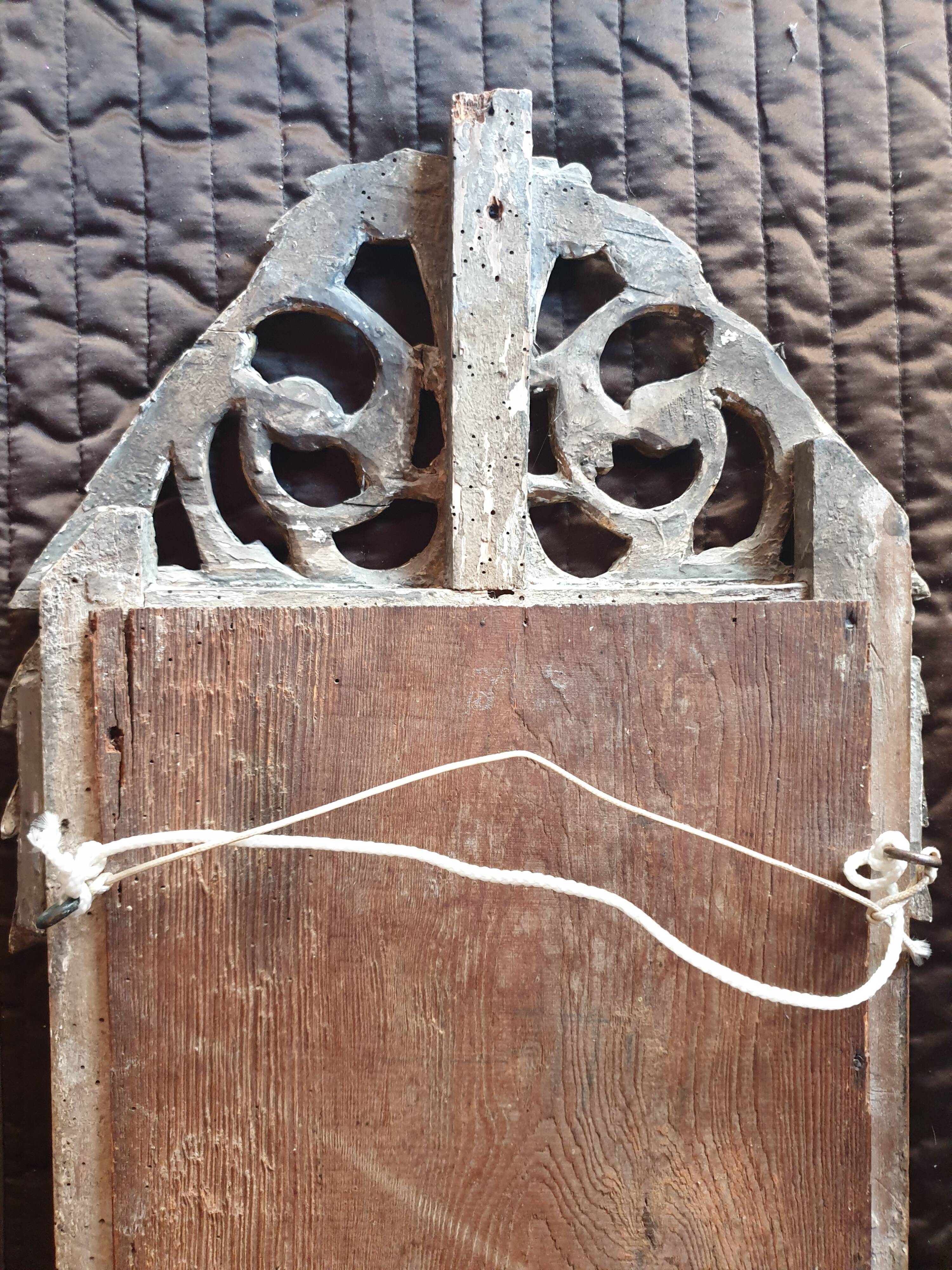 Old mirror in carved and gilded wood