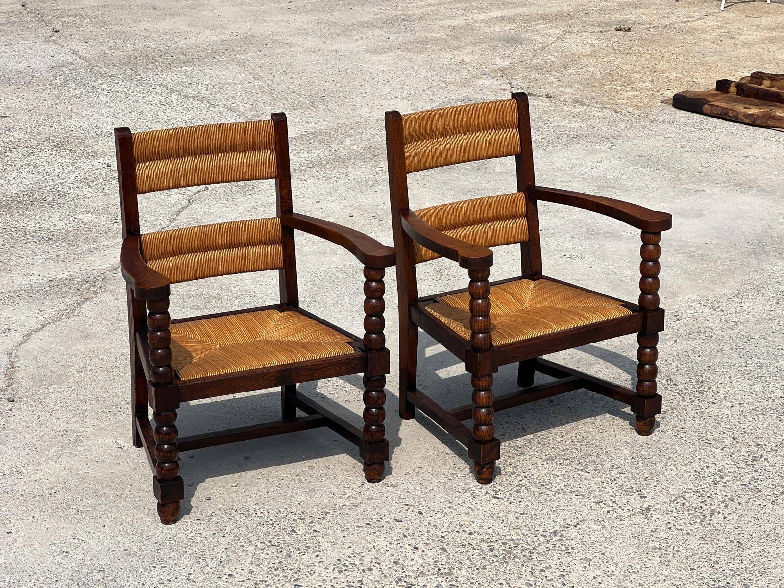 Pair of stained oak and straw armchairs, French work, 1950