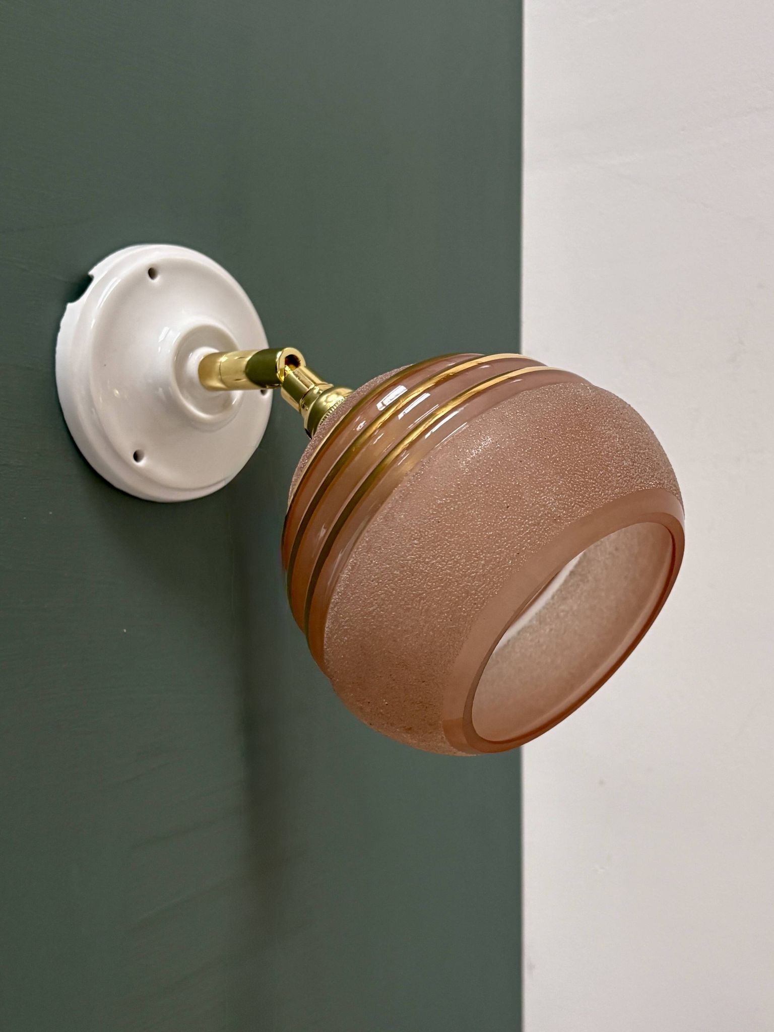 Vintage globe wall light in frosted pink and gold glass.