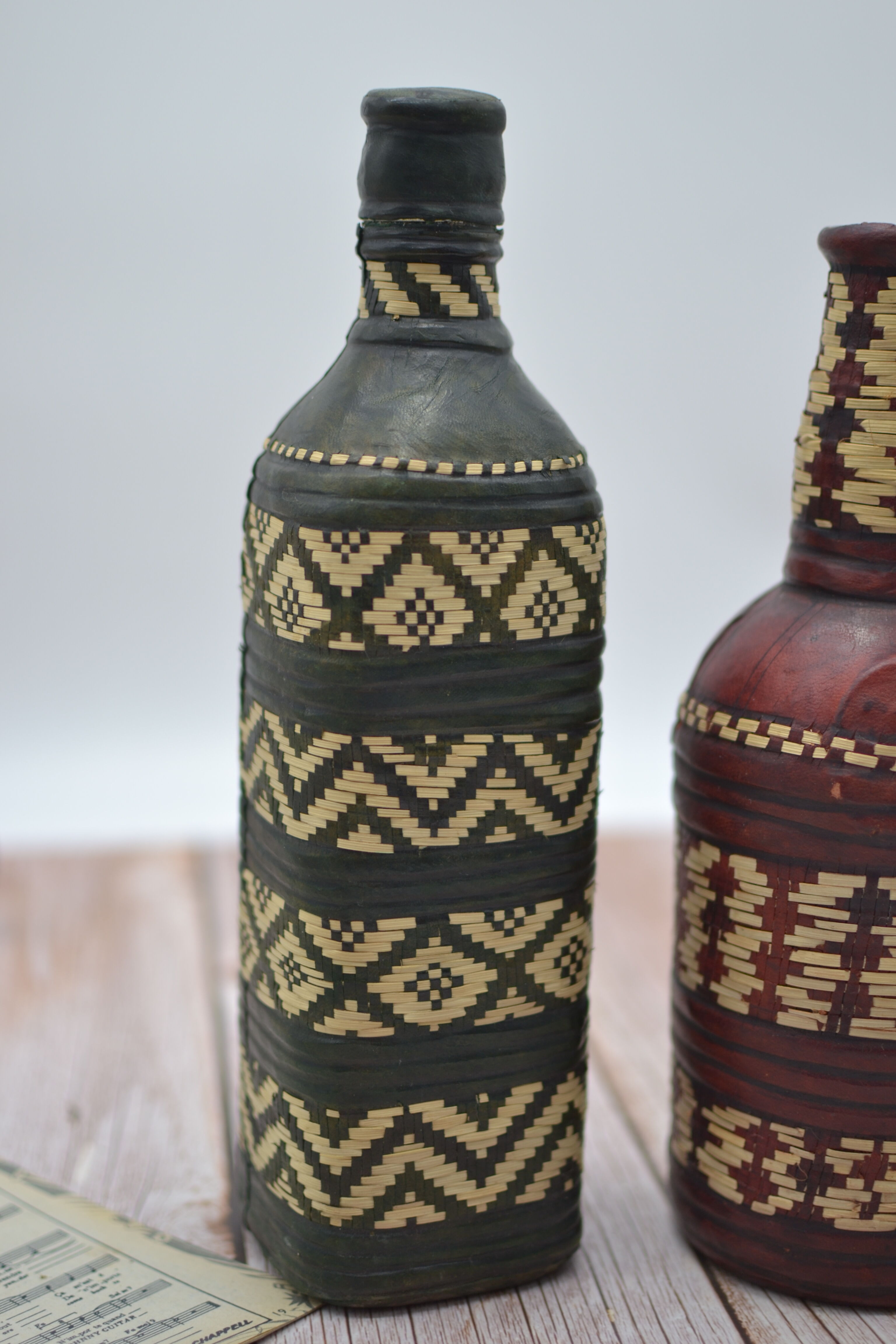 Set of 2 decorative vintage bottles covered with leather & wicker