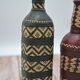 Set of 2 decorative vintage bottles covered with leather & wicker