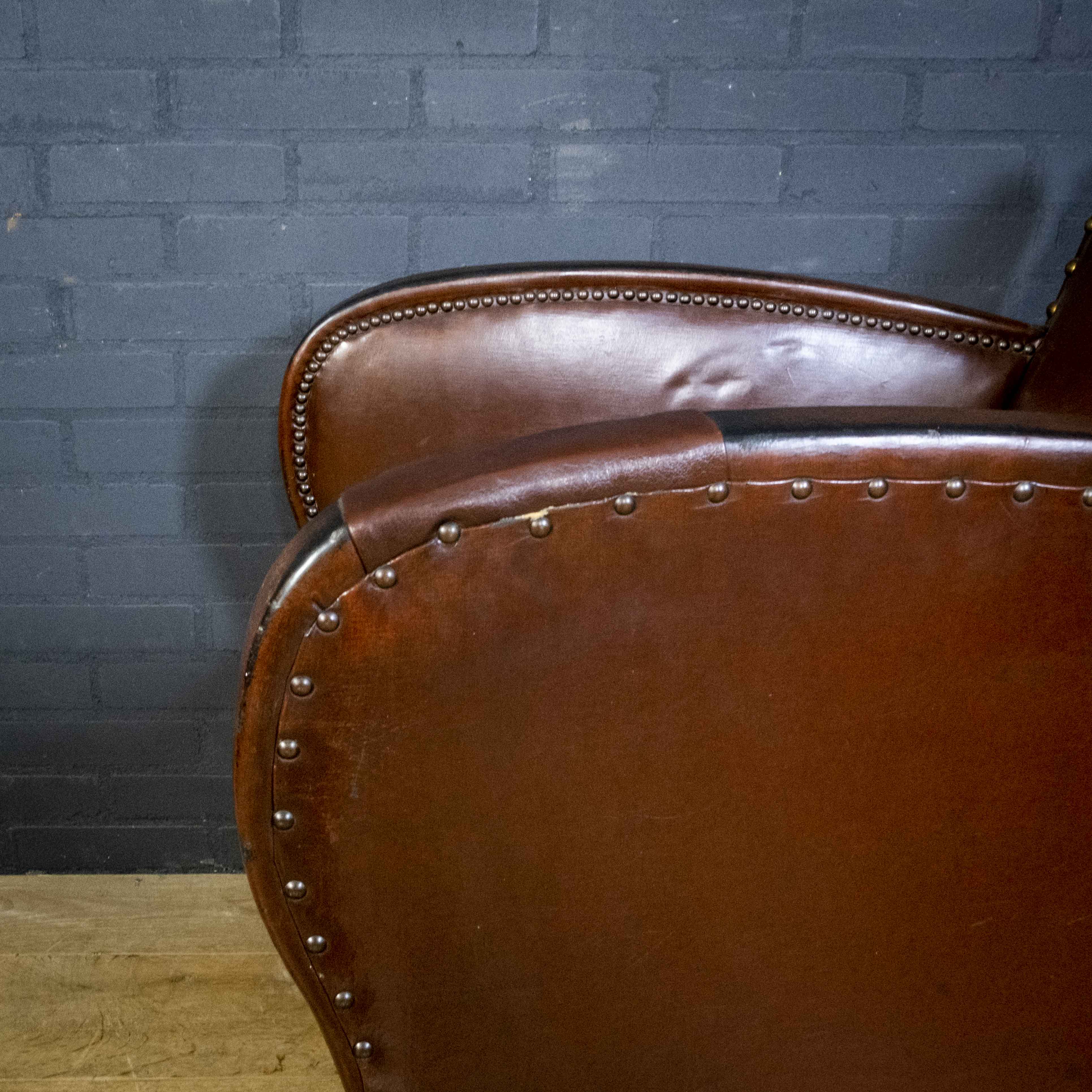Antique club armchair of leather cloth