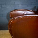 Antique club armchair of leather cloth