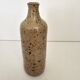 Pyrite stoneware single-flower vase in the shape of a bottle signed Aular?