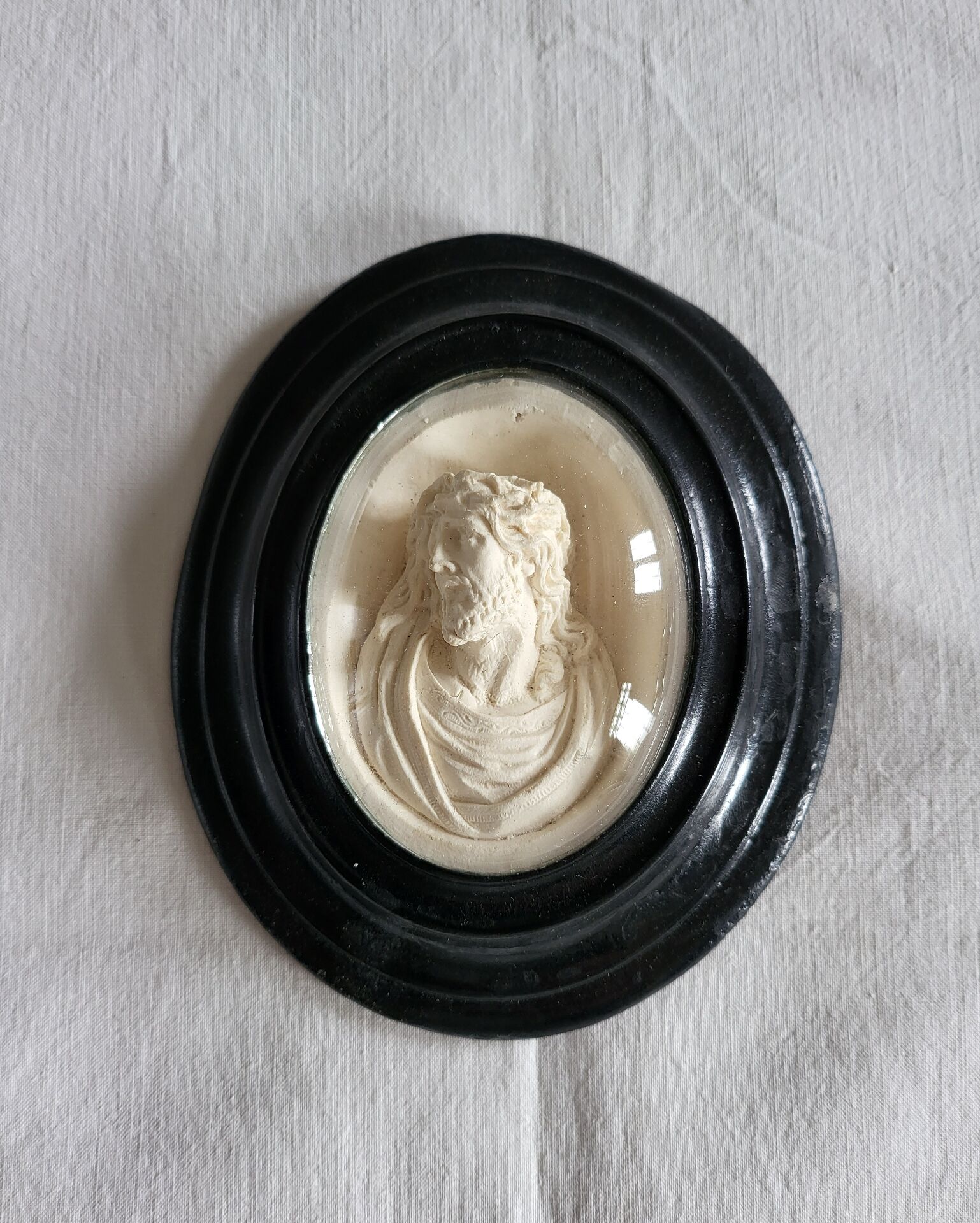Ancient religious medallion, Jesus Christ in plaster with a blackened wooden frame.