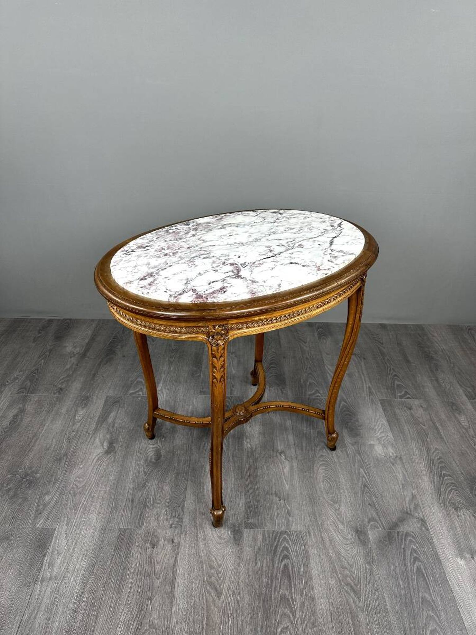 Oval guéridon table in carved wood and marble, Louis XVI style, 19th century.