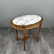Oval guéridon table in carved wood and marble, Louis XVI style, 19th century.