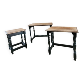 Nest tables in wood and black.