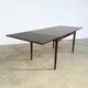 Rosewood dining table with integrated extensions — Denmark, 1960s