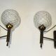 Pair of brass wall lights with glass globes. Around 1970.