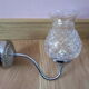 Pair of wall brackets in chromed metal and cut glass
