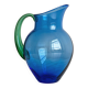 Translucent blue glass jug with a green handle.