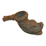 Cast iron gutter downspout in the shape of a dolphin