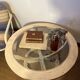 Oval patinated wood and beveled glass coffee table