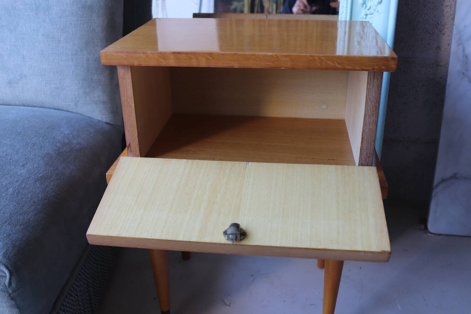 Modernist bedside table from the 1950s with compass legs.