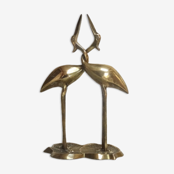 Couple intertwined brass herons